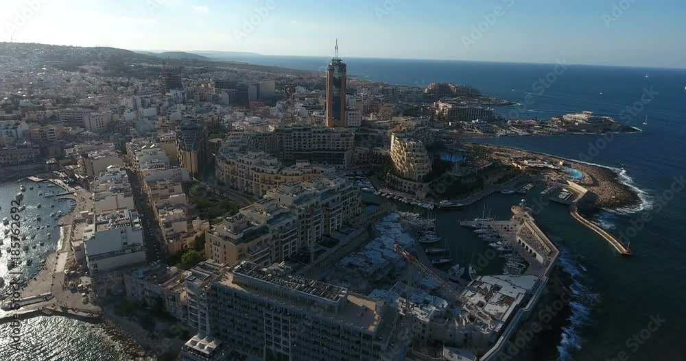 MALTA – AUGUST 2016 : Aerial shot of Sliema beach on a sunny day with hotels and boats in view MALTA – AUGUST 2016 : Aerial shot of Sliema beach on a sunny day with hotels and boats in view