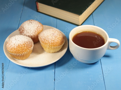 muffins with a mug of tea and a book