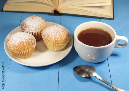 muffins with a mug of tea and a book