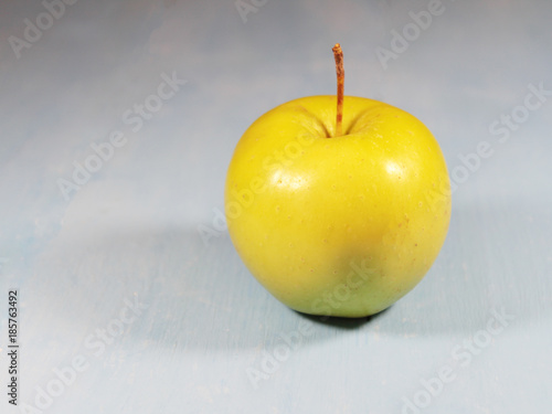 yellow apple on a blue background