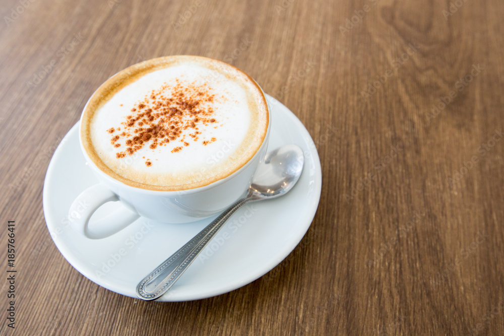 hot cappuccino on wooden table hot cappuccino on wooden table