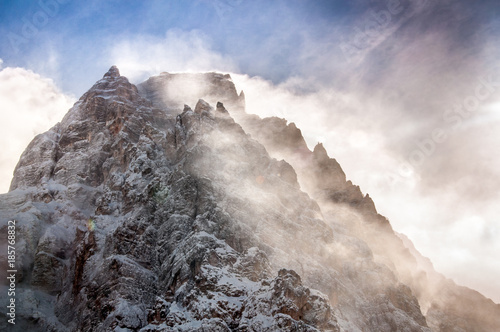 Winter view of Mount Pelmo summit with clouds, Dolomites, Italy