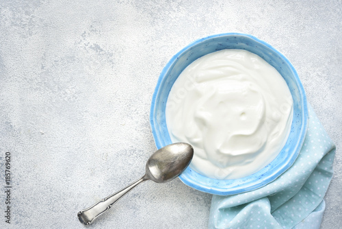 Natural yogurt in a bowl for a breakfast.Top view with copy space.