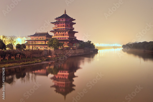 Ancient pagoda beside a quiet river during twilight, Nanjing, China