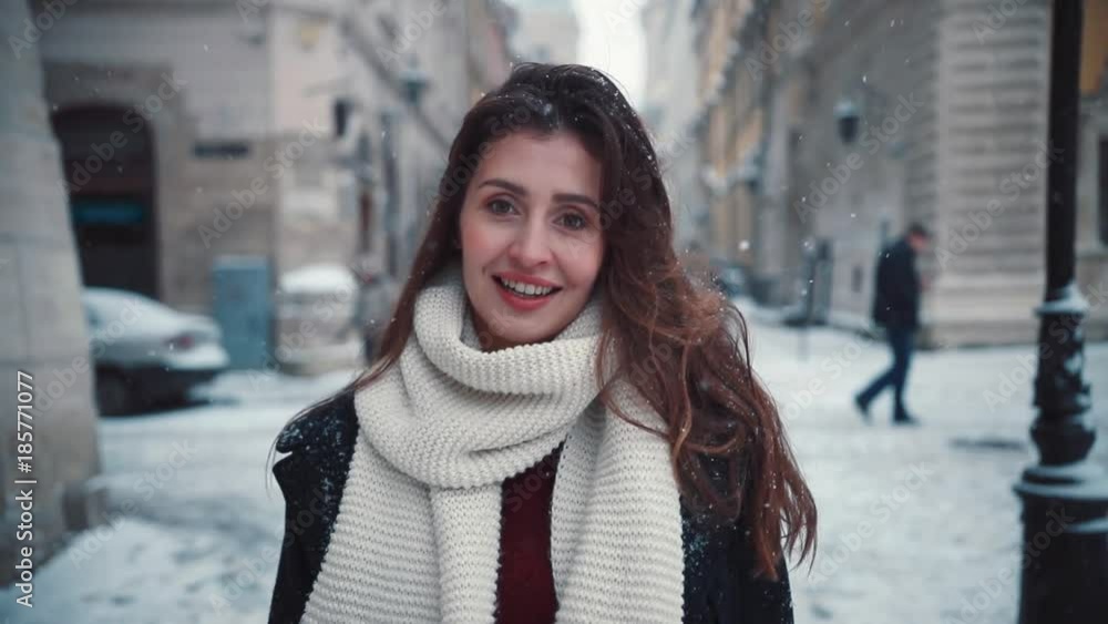Smiling happy young woman with long hair walks around the city portrait charming christmas fun girl holiday happiness young casual beauty celebration close-up attractive face snow winter Smiling happy young woman with long hair walks around the city portrait charming christmas fun girl holiday happiness young casual beauty celebration close-up attractive face snow winter