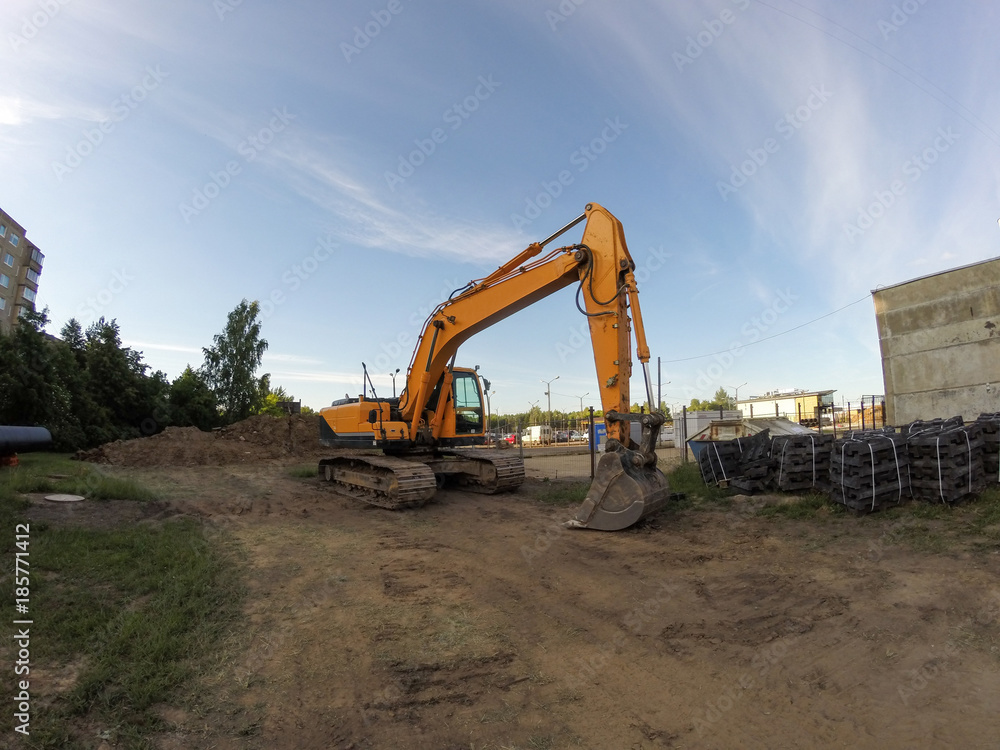 Yellow excavator in the construction site Yellow excavator in the construction site