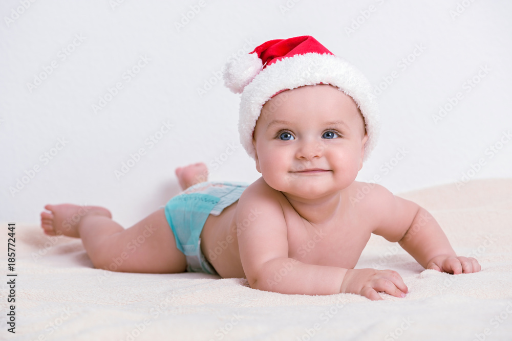 Cute little 5 months old baby boy wearing Santa Claus hat Cute little 5 months old baby boy wearing Santa Claus hat
