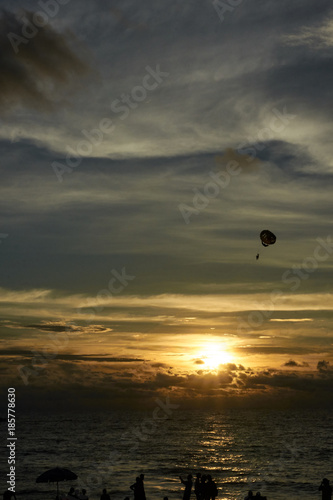 Sunset at sea. Parachute. Free flight