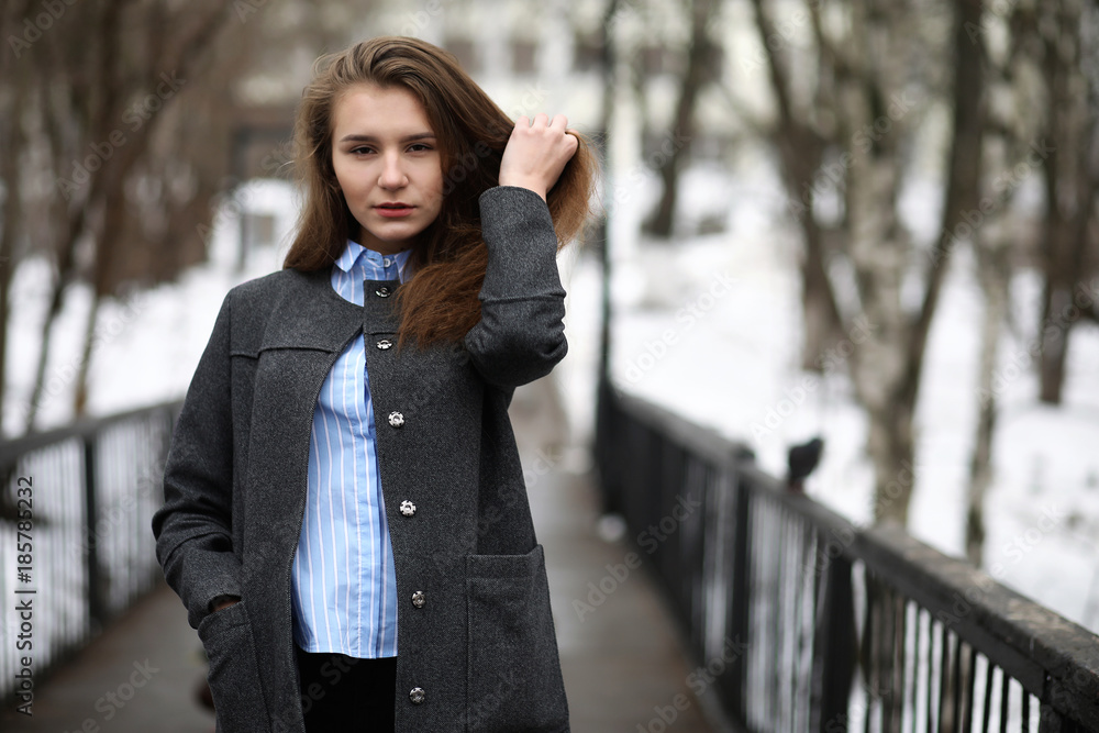 Young adult girl in coat on the street Young adult girl in coat on the street