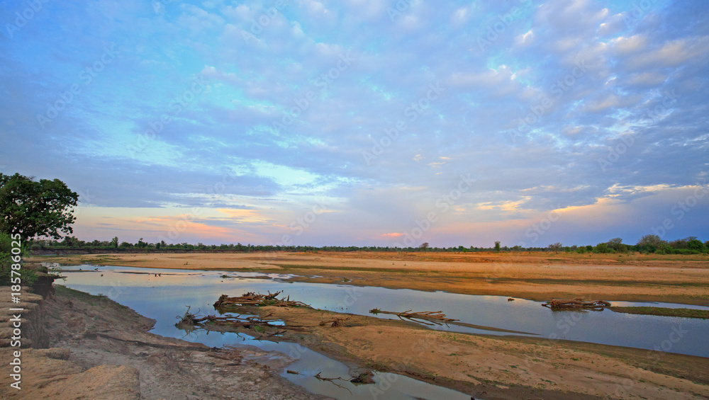 Scenic view of the Luangwa River at sunset, with a nice cloudscape in South Luangwa National Park, Zambia, Southern Africa Scenic view of the Luangwa River at sunset, with a nice cloudscape in South Luangwa National Park, Zambia, Southern Africa