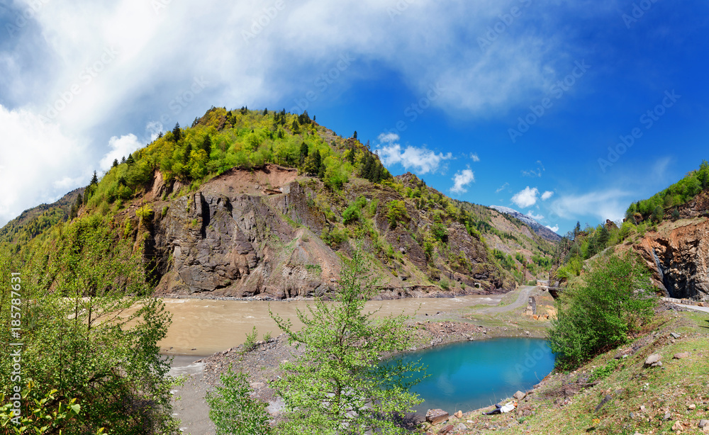 Panoramic view of crystal blue lake and woodland in Georgia. Lajanuri reaservoir near Usakhelo, Racha. Caucasus. Colorful vibrant outdoors