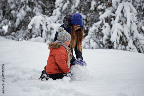 winter fun. a girl and a boy making snowballs.