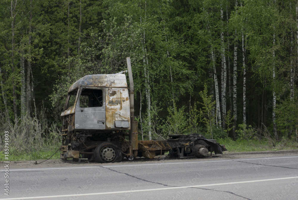 Burned truck at the road side