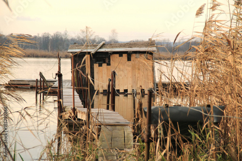 bizzare post-apo looking cottage with narrow catwalk on Hermanicky pond, Czech Republic photo