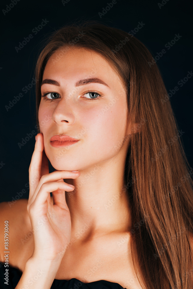 Portrait beautiful girl on a dark studio background Portrait beautiful girl on a dark studio background