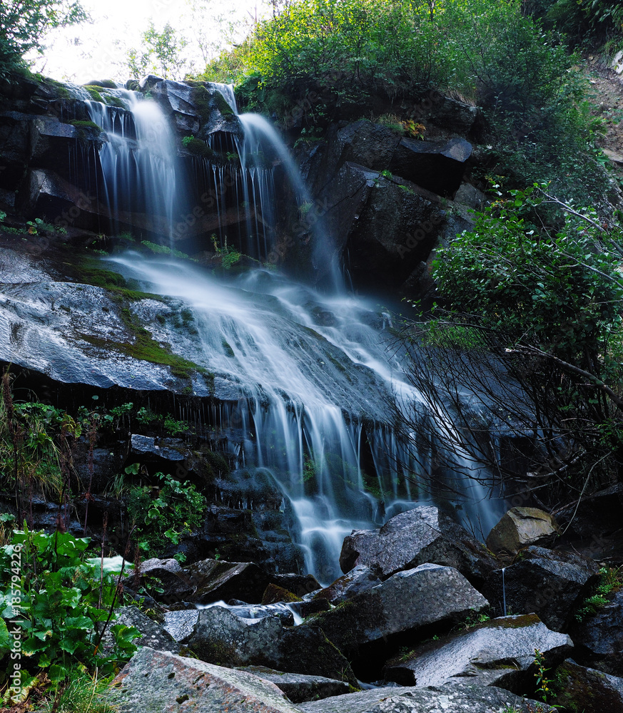 Obraz premium Waterfall at the carpatian mountains green forest