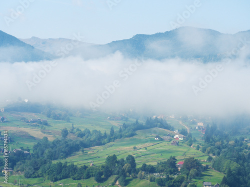 Fog and mist at the village in the carpatian mountains