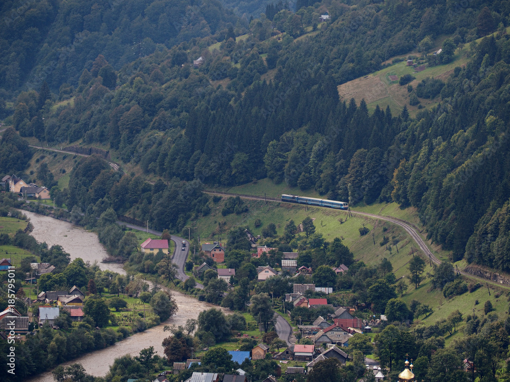 Fototapeta premium Carpatian mountains village at green forest