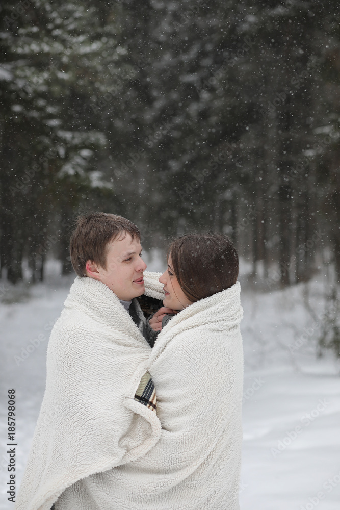pair of lovers on a date winter afternoon in a snow blizzard pair of lovers on a date winter afternoon in a snow blizzard