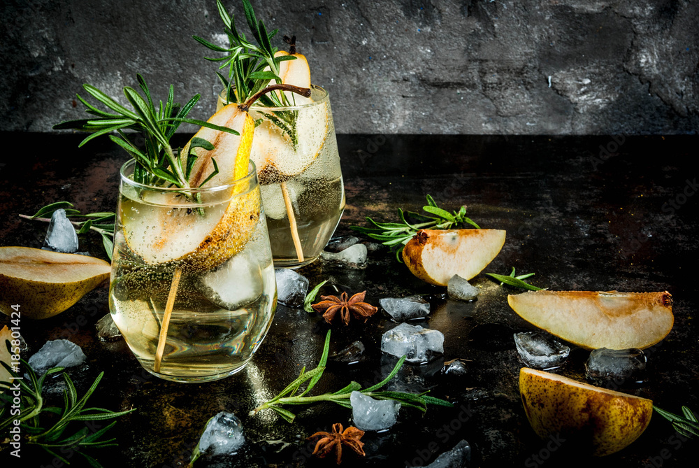 Fototapeta premium Sweet pear and rosemary cocktailAlcohol drink, Sweet pear cocktail with rum, liquor, anise and rosemary, On a black rusty metallic background, copy space