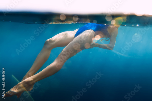 Girl posing underwater with blue bikini