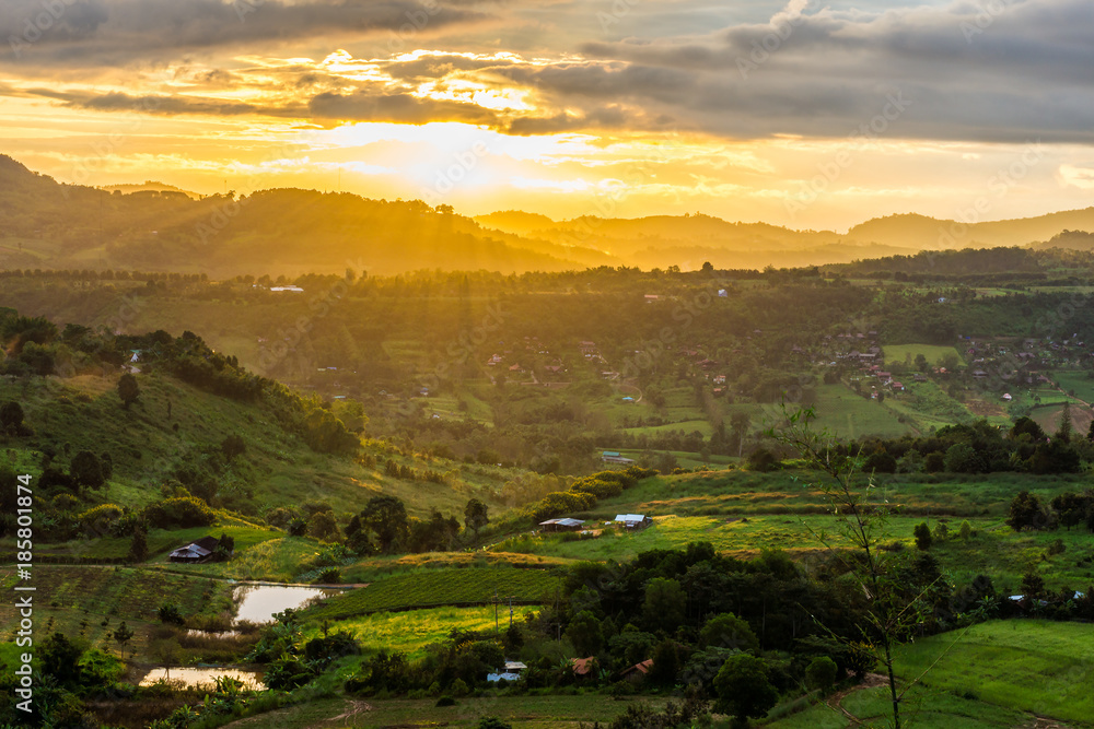 Aerial scenery view of sunrise over mountain range at rural village. Location in Khao Kho District, Phetchabun, Thailand, Southeast Asia.