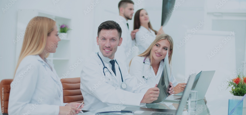 Smiling doctors working at office desk and smiling at camera, me Smiling doctors working at office desk and smiling at camera, me