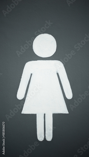 A lady toilet sign on the green wall background