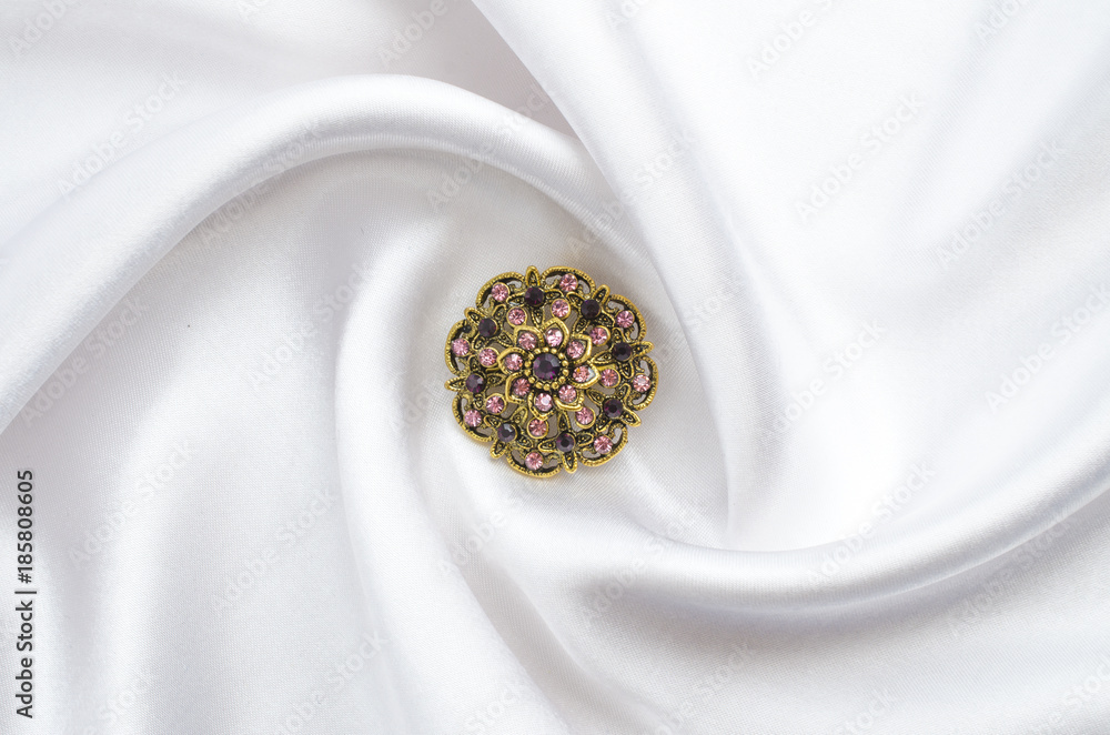round brooch with gems on silk round brooch with gems on silk