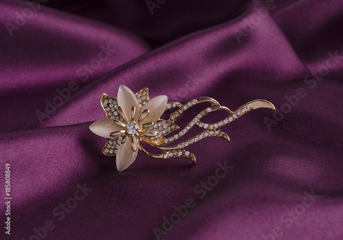 gold brooch flower with gems and moon stone on silk