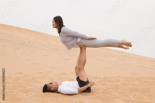 Indonesian girl and Filipino boy doing yoga on Dune 7, Walvis Ba