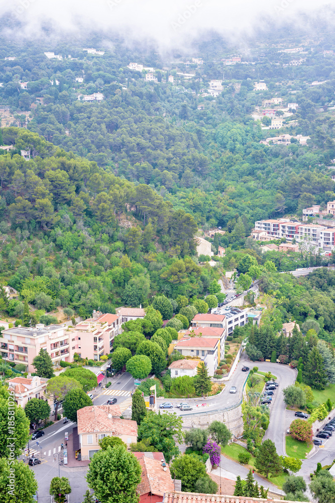 Daylight foggy view to Eze, Cote d'Azur village with medieval houses