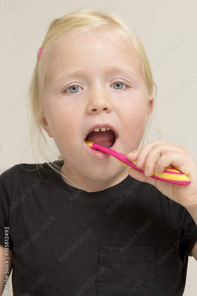 Little Girl in Black Shirt Brushing Her Teeth Little Girl in Black Shirt Brushing Her Teeth