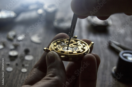 A watch maker is repairing a vintage automatic watch. photo