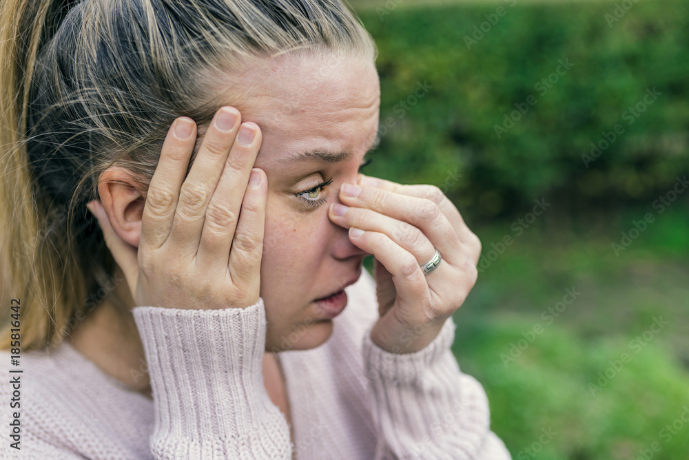 Sinus ache causing very paintful headache. Unhealthy woman in pain