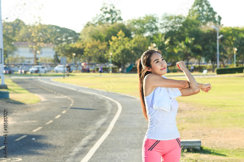 A women is exercising and relaxing at the park.