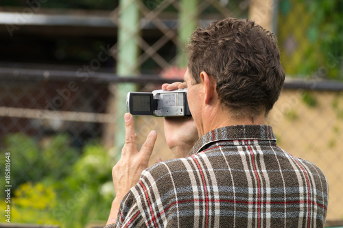 One man with the video camera on the nature