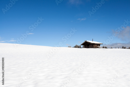 South tirol snow landscape and wooden cabin