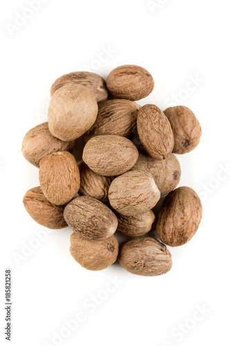 Pile of nutmeg seeds isolated on a white background photo