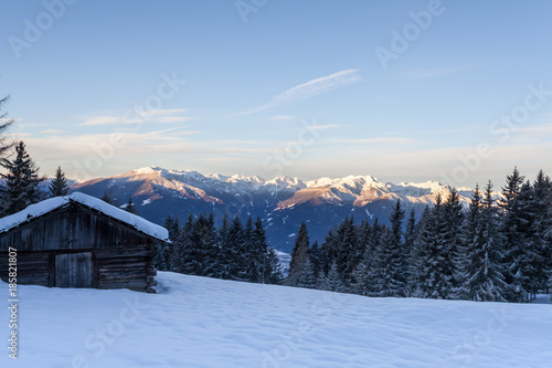 South tirol snow mountains landscape and wood cabin winter travel