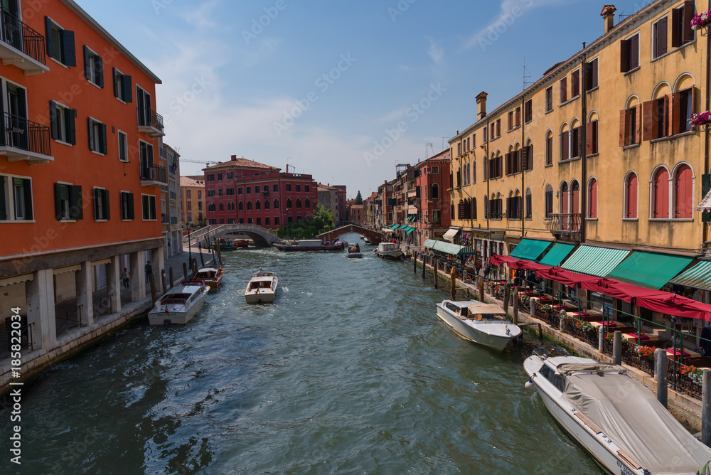 Obraz premium Traditional narrow canal street with gondolas and old houses in Venice, Italy. Architecture and landmarks of Venice. Beautiful Venice postcard.