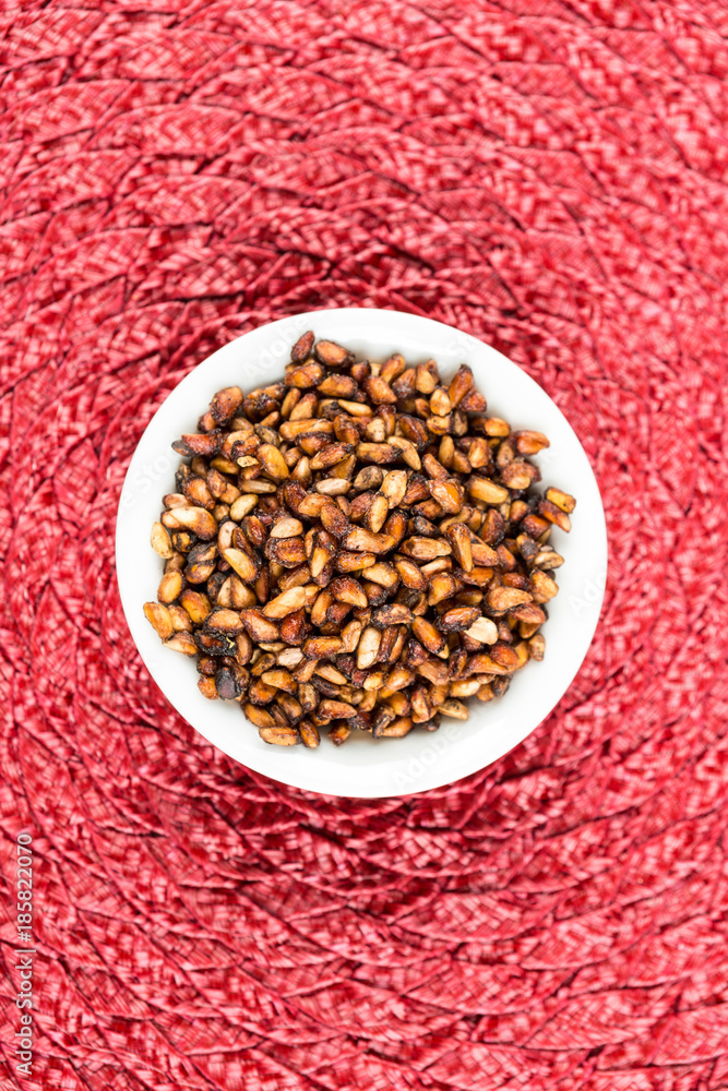 Pile of dried pomegranate seeds on a cloth background Pile of dried pomegranate seeds on a cloth background