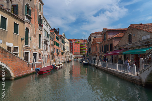 Fototapeta Naklejka Na Ścianę i Meble -  Traditional narrow canal street with gondolas and old houses in Venice, Italy. Architecture and landmarks of Venice. Beautiful Venice postcard.