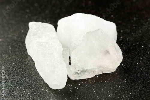 Crystallized alum chunks isolated on a black background photo
