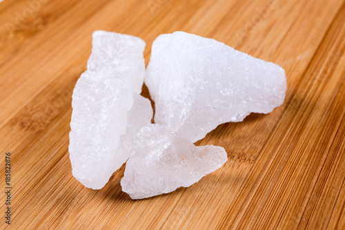 Tablou pe pânză Crystallized alum chunks isolated on a wood background