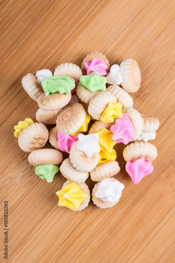 Small frosted cookies isolated on a wood background Small frosted cookies isolated on a wood background
