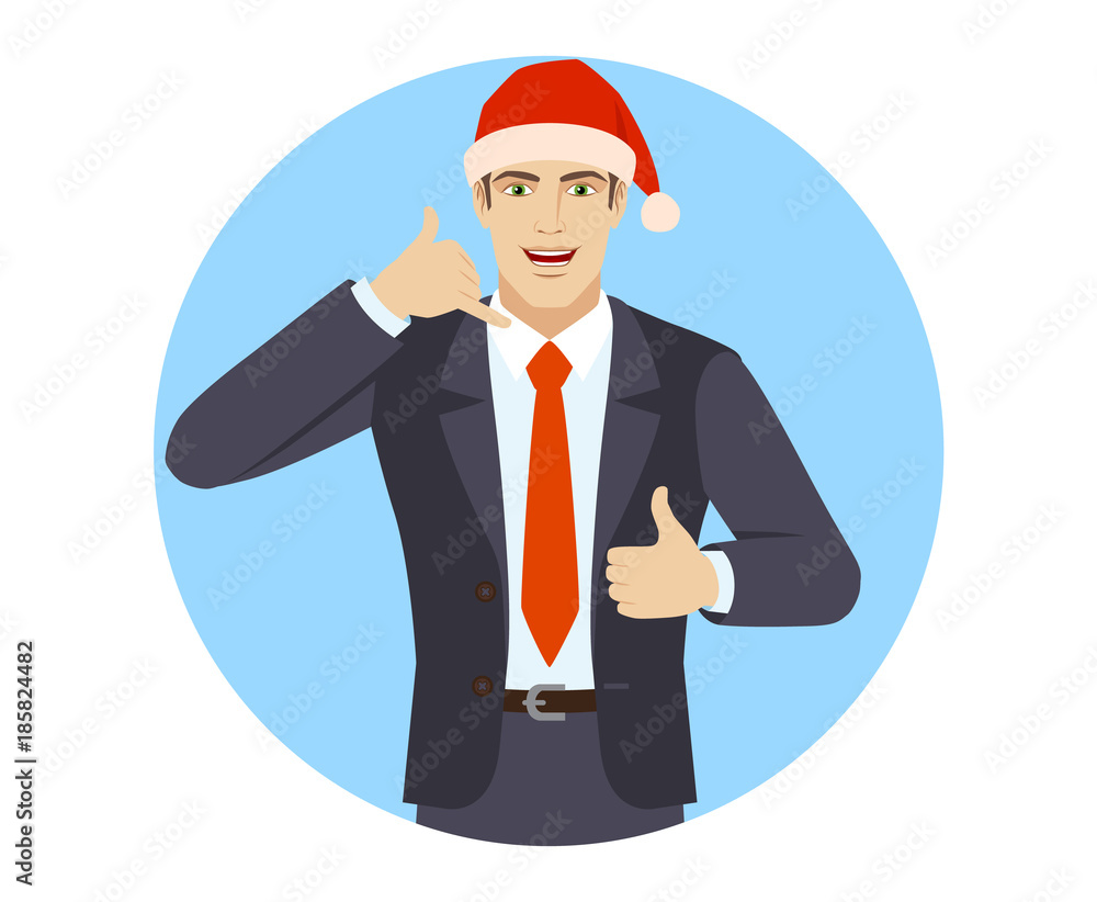 Businessman in Santa hat showing a call me sign and showing thumb up Businessman in Santa hat showing a call me sign and showing thumb up