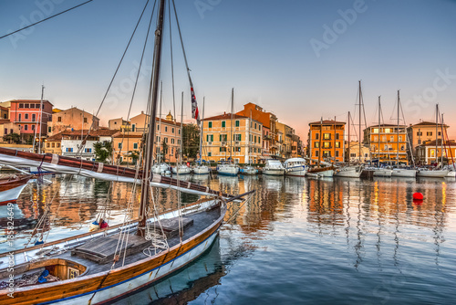 Boats in La Maddalena harbor at sunset photo