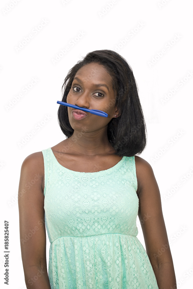 Woman holding pen between nose and lip Woman holding pen between nose and lip