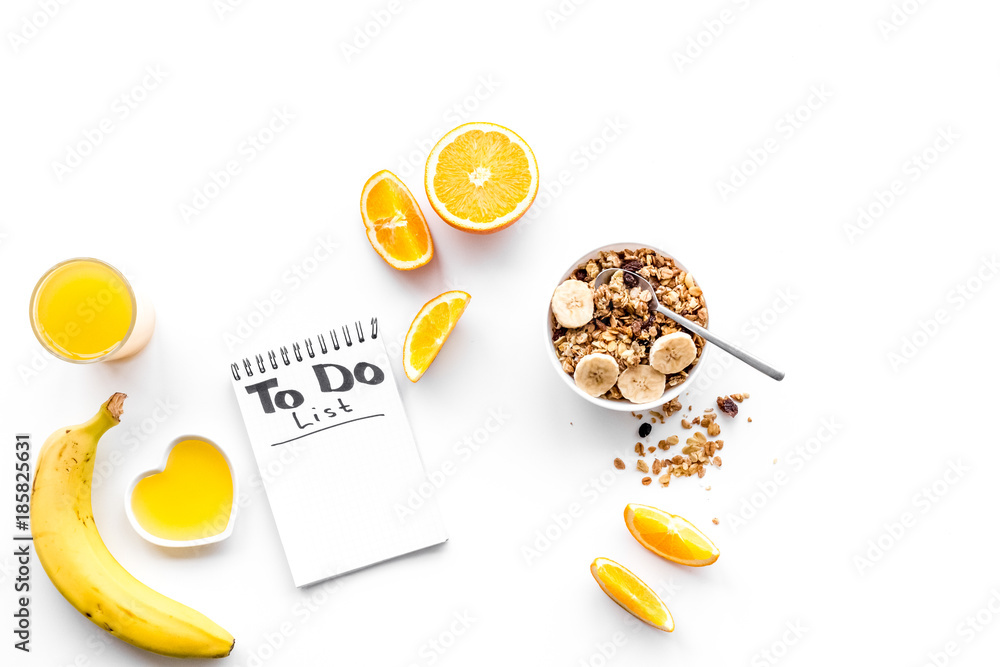 Morning habits of successful people. Healthy breakfast porridge with fruits and planning the day. White background top view